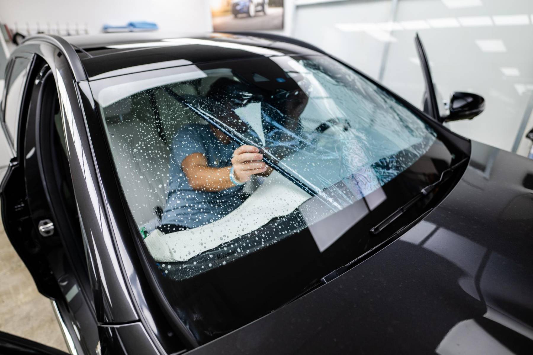 Ceramic film being installed on a windshield at Lakewood Ranch Tint